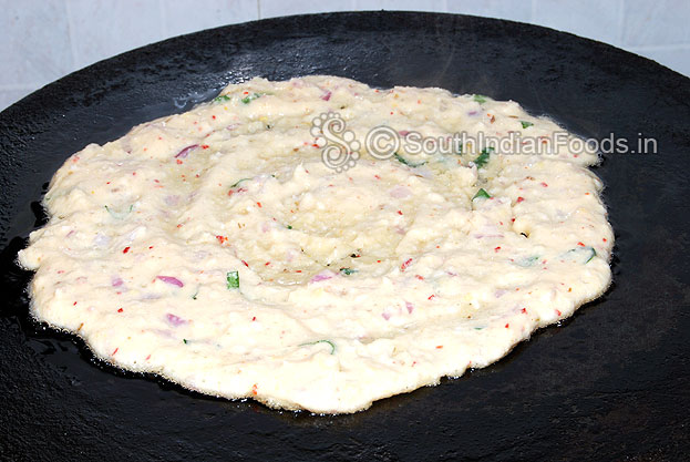 Heat iron dosa tawa, pour batter, spread then add oil, cover it & cook both sides