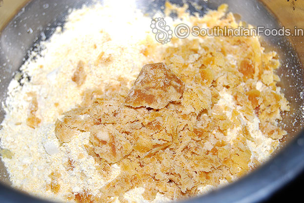 In a bowl add freshly ground corn powder, jaggery, cardamom powder mix well.