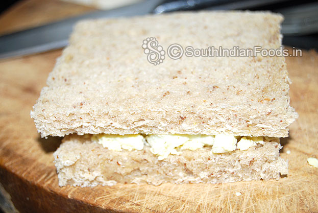 Grease bread slices with mayonnaise then place crumbled egg, press gently, then cut into half and serve with green chutney