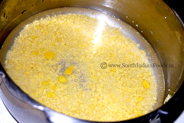 Heat pressure cooker, add thinai, moong dal, water & ghee, cover lid, cook for 4 whistles