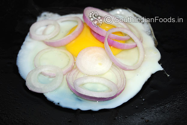 Heat oil in a pan, pour one egg then place onion rings