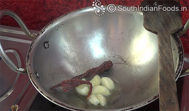 Heat oil in a pan , add garlic & dry red chilli