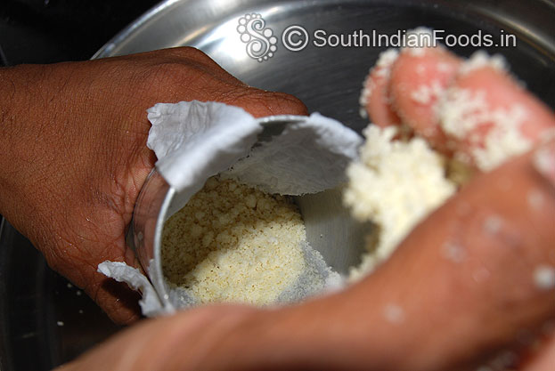 Add prepared puttu mixture to the puttu kuzhal