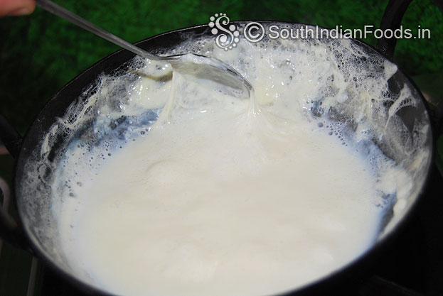 Take malai in a spoon, grease on the side of of the pan