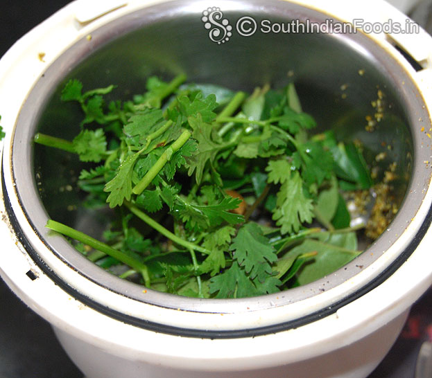 Add curry leaves, coriander leaves, green chilli, water in a mixer jar & finely grind