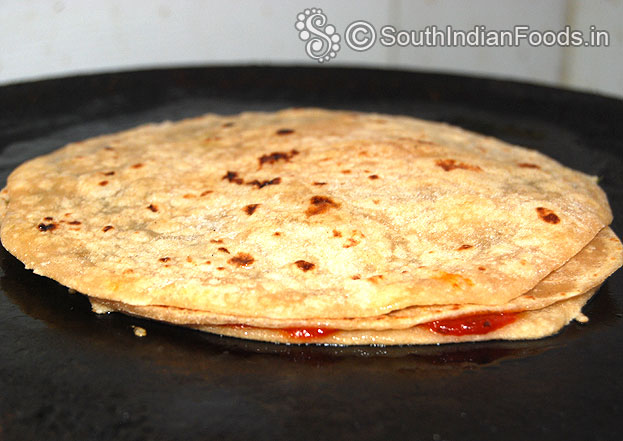 Cover with another chapati, heat iron tawa, place chapati, cook both sides