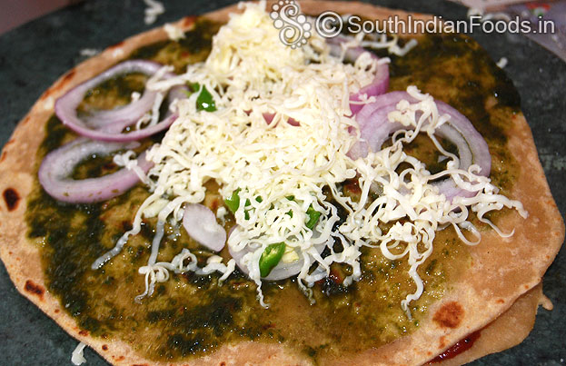 Grease chapati with green chutney, grate cheese, add onion, green chilli