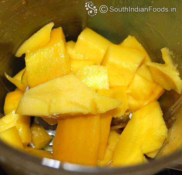 Add mango cubes in a blender / Mixie jar