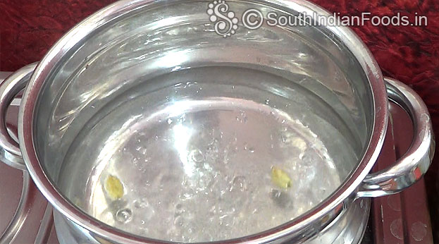 Boil water with green cardamom pods