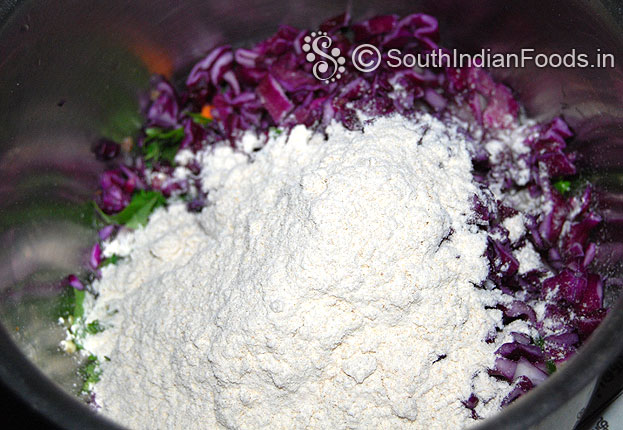 In a bowl add red cabbage carrot curry coriander leaves green chilli onion wheat flour mix well