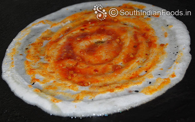 Place 2 tbsp of schezwan saute spread over the dosa