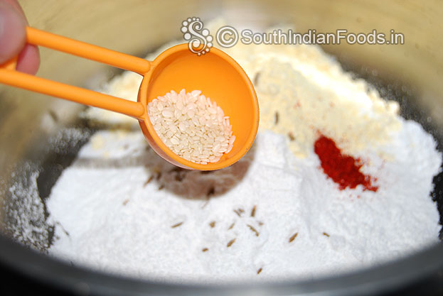 In a bowl add rice flour, gram flour, roasted gram flour, red chilli powder, cumin seeds & sesame mix well
