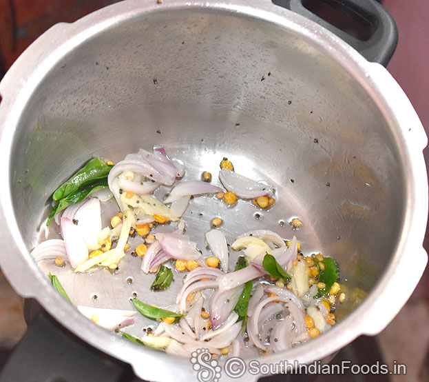 Heat 2 tbsp oil in a pressure cooker add mustard, urad dal, bengal gram, garlic, green chilli & curry leaves