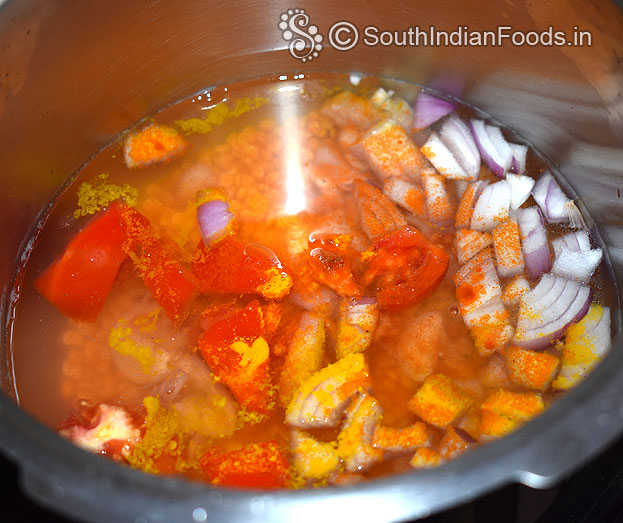 Heat pressure cooker add toor dal, tomato, onion, garlic, turmeric, green chilli, gingelly oil 