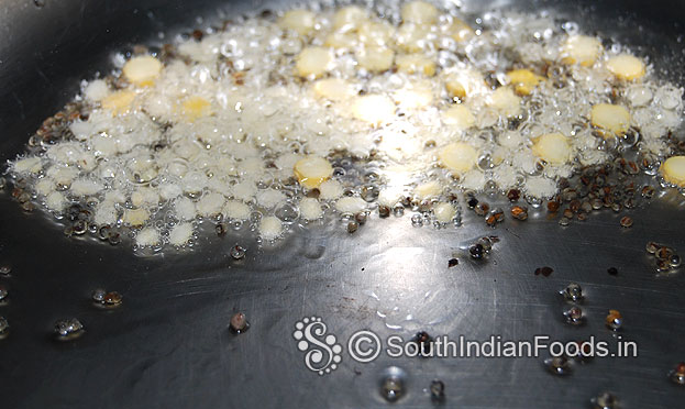 Heat oil in a pressure cooker, add mustard seeds, bengal gram & urad dal