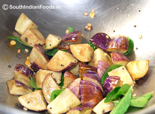 Seasoning with mustard, bengal gram, urad dal, curry leaves& brinjal