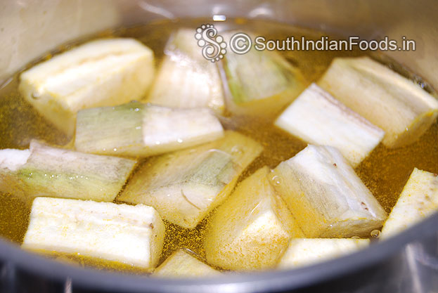 Peel off the raw banana skin, cut into cubes, then boil with salt & turmeric powder