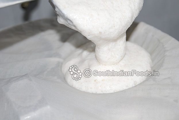 Heat traditional idli vessel with water, let it boil, cover idli plates with wet soft cotton cloth then pour batter