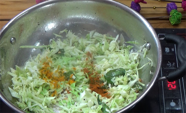 Add grated cabbage, turmeric, red chilli powder, salt
