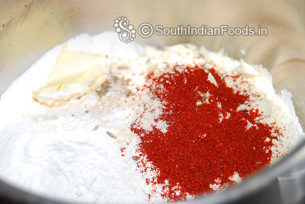 In a bowl add rice flour, roasted gram flour, urad dal flour, asafetida, sesame seeds, cumin red chilli powder, butter and salt mix well then add water make soft dough