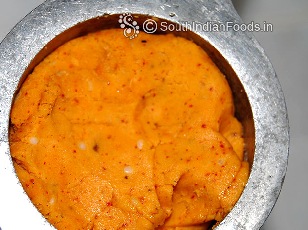 Put handful of dough in a murukku kuzhal