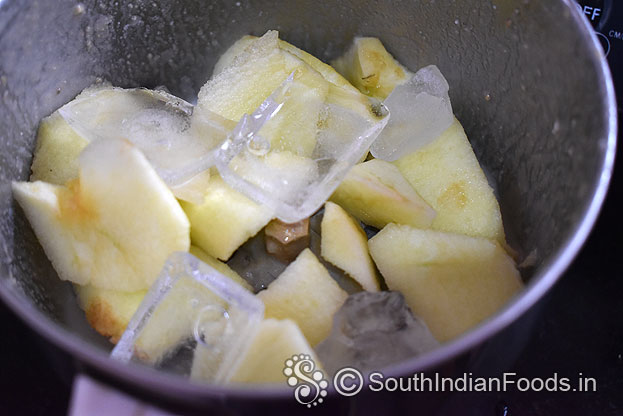 In a blender add apple , ice cubes