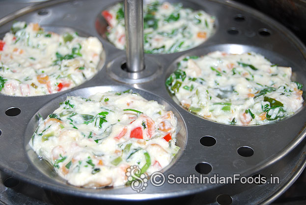 Grease idli plates with oil, pour batter, steam it for 10 min