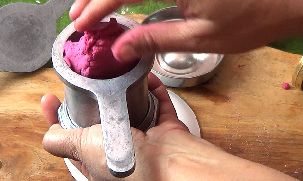 Put one handful dough into the murukku kuzhal