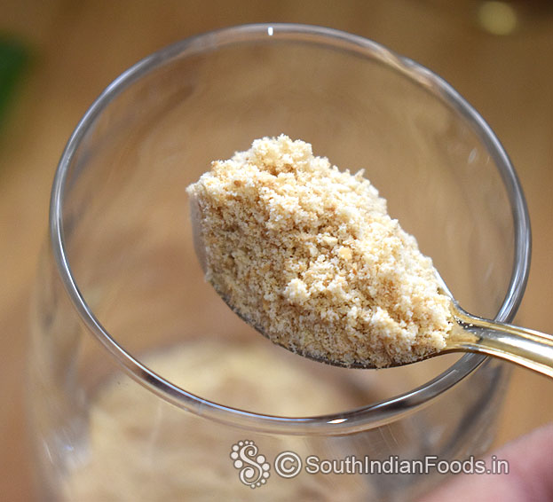 In a serving glass, add ground marie biscuit