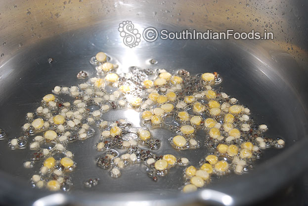 Heat oil in a pressure cooker add mustard, bengal gram, and urad dal saute