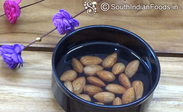Wash & soak badam in hot / warm water for 1 hour