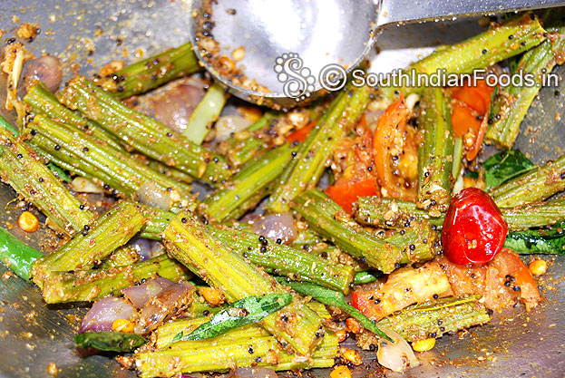 Parboil drumstick, Heat oil in a pan add mustard, bengal gram, urad dal & onion saute till soft. Add garlic,dry red chilli, curry leaves, asafetida, fenugreek powder mix well. Add tomato saute till soft. Add parboiled drumstick, salt, turmeric, red chilli & freshly ground powder saute well.