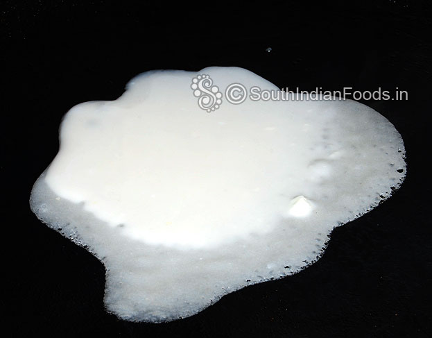 Pour rice flour,maida, curd & salt mixture on iron dosa tawa