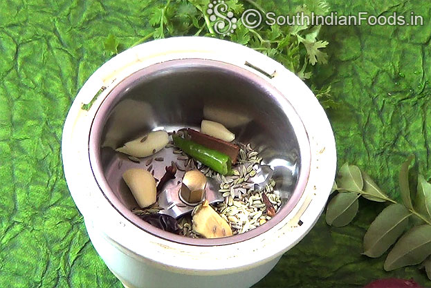 Add garlic, ginger, green chilli, dry red chilli, cinnamon, cumin, cloves, fennel coarsely grind