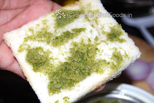 Grease both bread slices with green chutney.