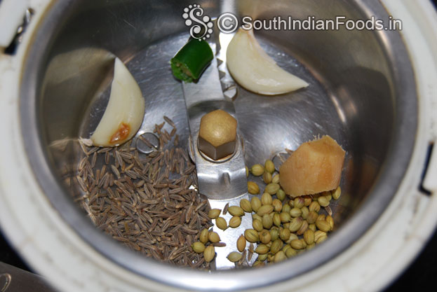 In a mixie jar, add garlic, green chilli, ginger, cumin and coriander seeds