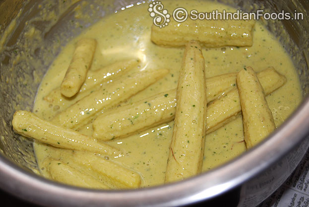 Make gram flour batter, add marinated baby corn