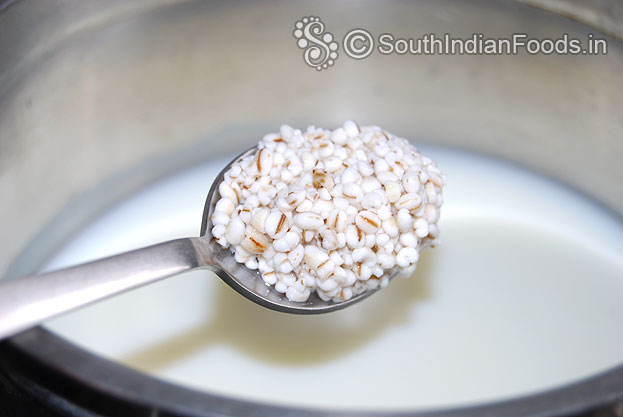 Heat water, milk in a pan add soaked barley & let it boil