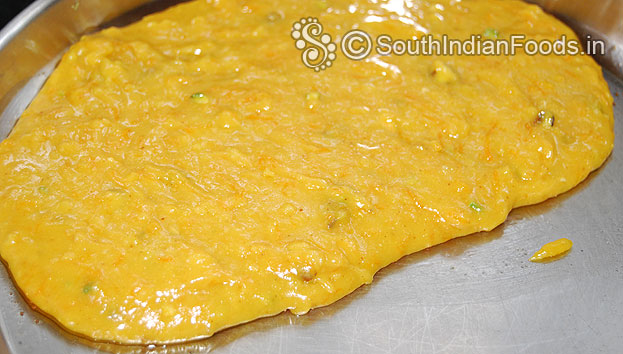 Pour the mixture into ghee greased tray