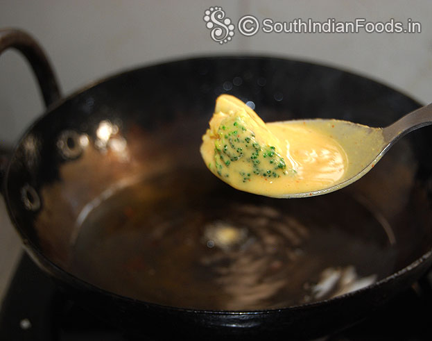 Drop broccoli in hot oil