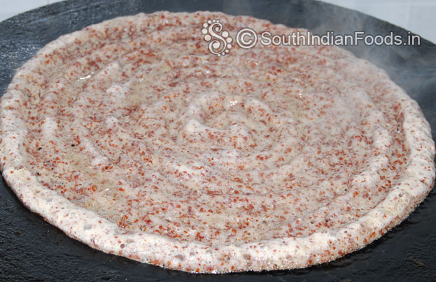 Heat iron dosa tawa, pour batter, shape, sprinkle oil & cover it