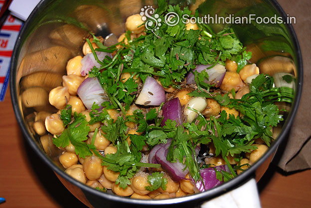 Add soaked chickpea, coriander, cumin, pepper, onion, garlic, salt, & cumin seeds coarsely grind