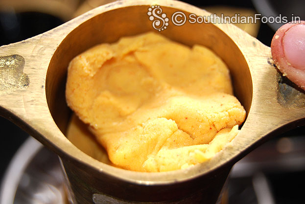 Put dough in a murukku kuzhal