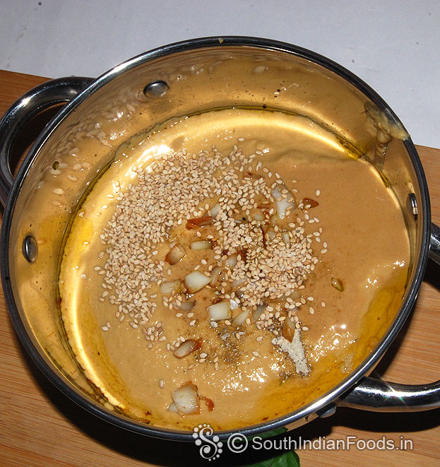 Add sesame seeds, coconut pieces