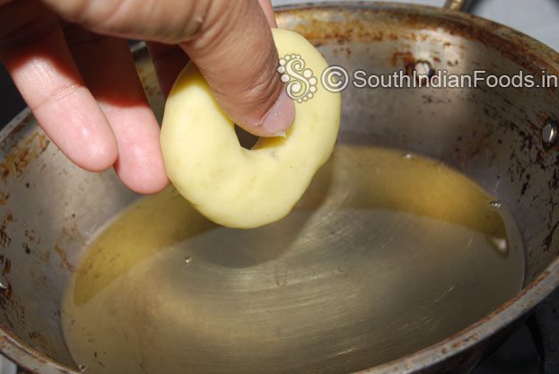 Heat oil in a pan. Then place donuts one by one.