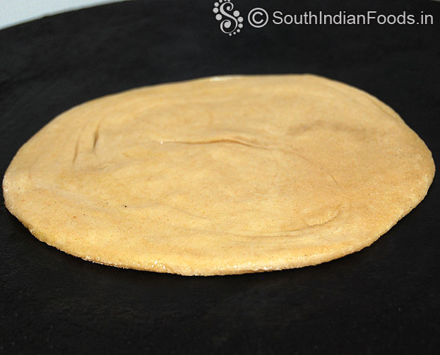 Heat iron dosa tawa, place paratha, cook till crisp and golden brown