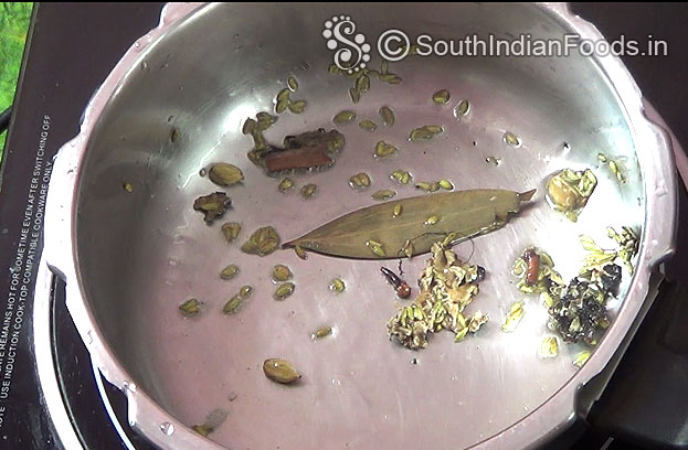 Heat pressure cooker, add spices