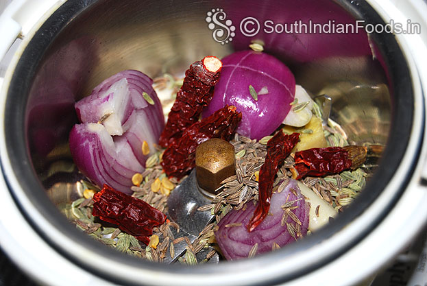 Add fennel seeds, cumin seeds, garlic, dry red chilli, ginger, onion in a mixer jar