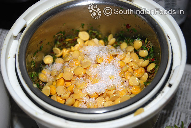 Add soaked toor dal channa dal salt coarsely grind without water