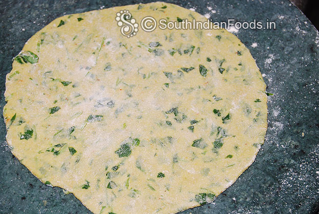 Sprinkle flour roll out to thick chapati